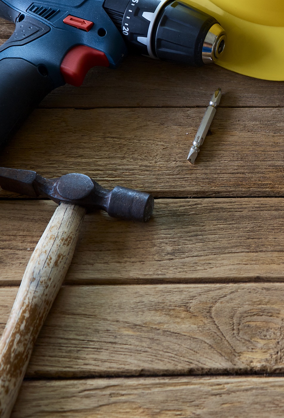 Tools and helmet on the wooden floor. Image with copy space. Labor day concept